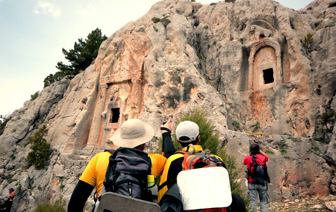 Tourists Hiking and Photo Shoot King tombs carved in Turkey